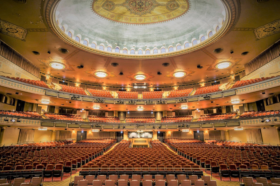 Interior of ASM Richmond's grand venue, featuring a stunning dome ceiling, ornate chandeliers, and multiple levels of seating.